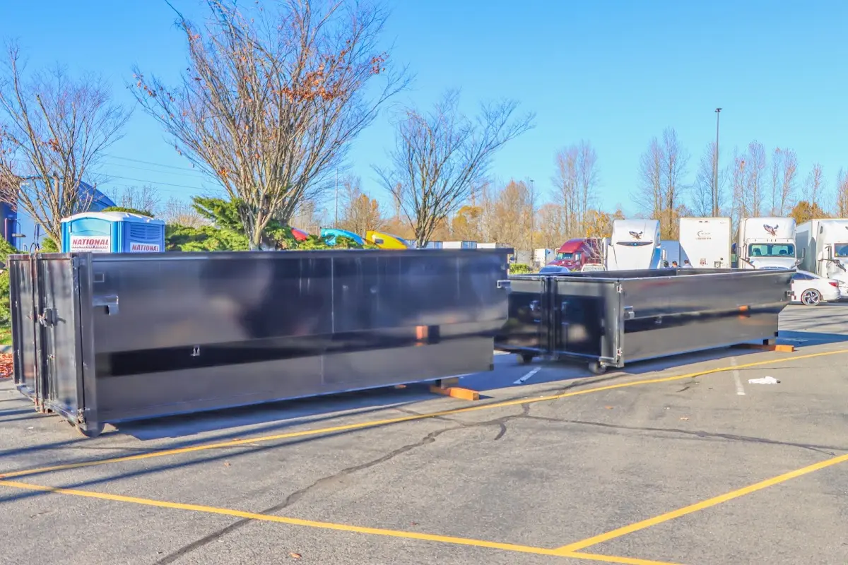 Professional dumpster rental service with roll-off container on residential driveway in Westmont